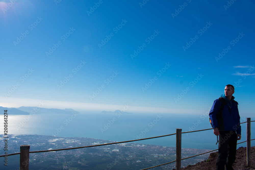 hiker in mountain and beautiful view on city from above on Vesuvius volcano 