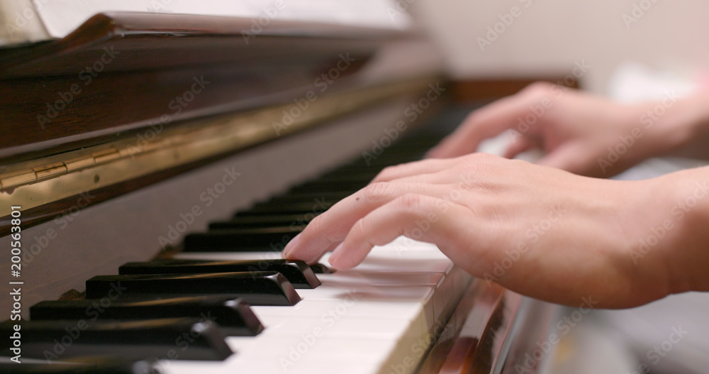 Fototapeta premium Man playing piano at home