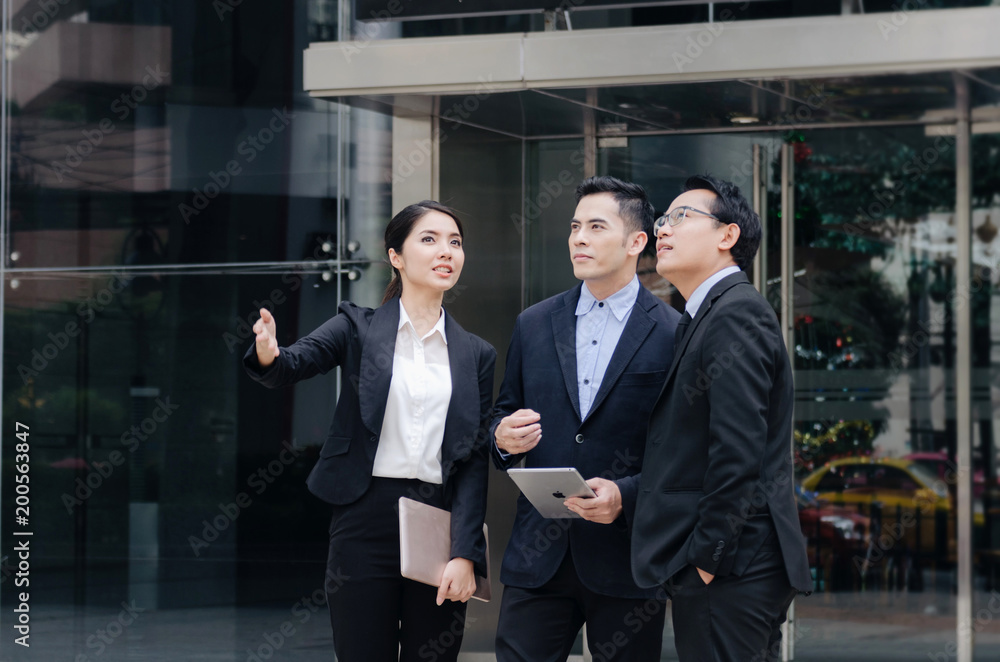 group of business people in suit talking and reading information about finance news in laptop computer together standing in modern city, network technology, internet, successful, teamwork concept group of business people in suit talking and reading information about finance news in laptop computer together standing in modern city, network technology, internet, successful, teamwork concept