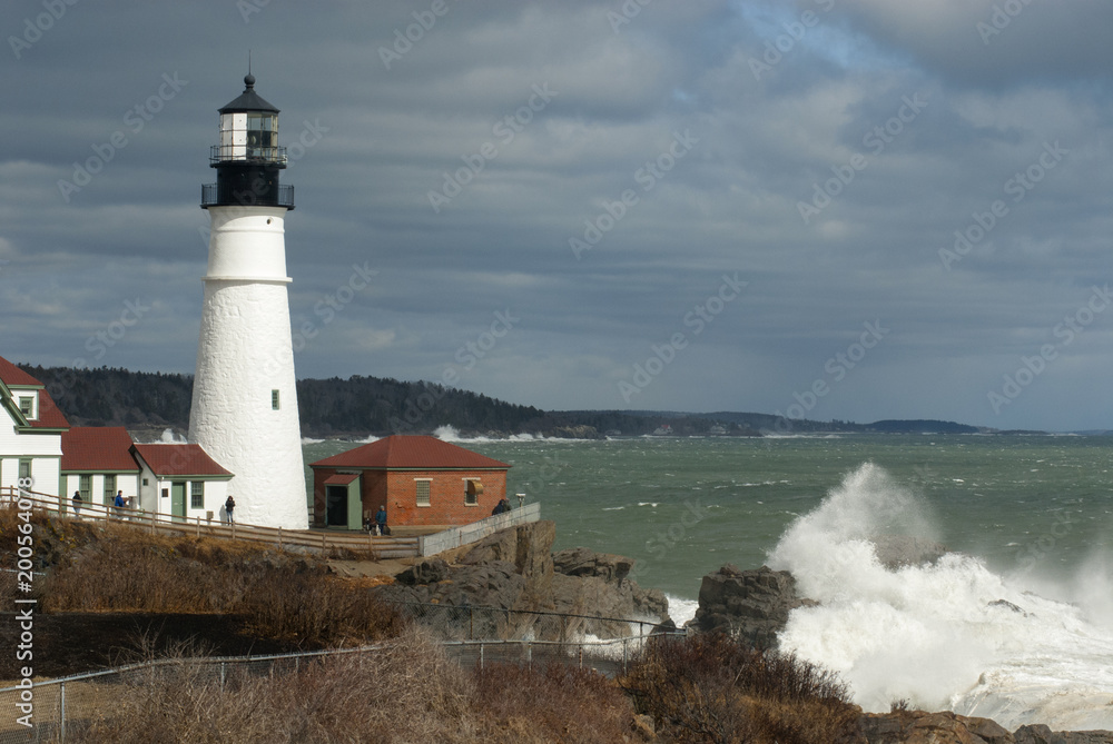 Huge Waves Break by Sunlit Portland Head Lighthouse in Maine