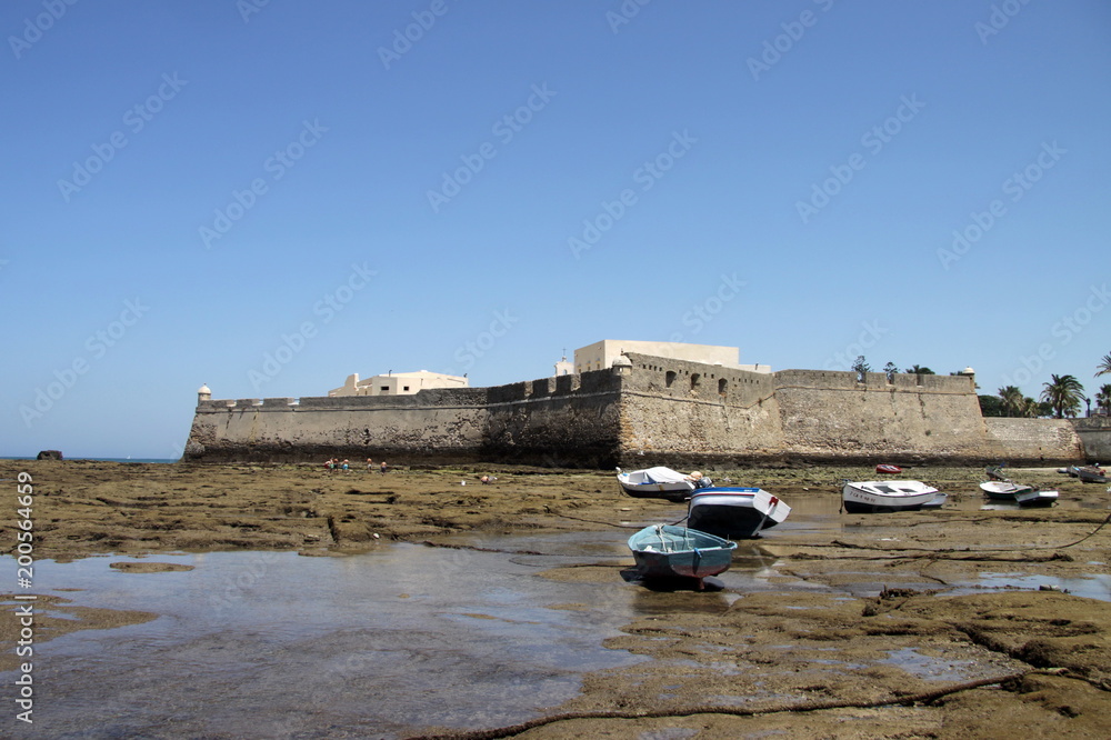 Boats off the coast of Cadiz near the fortress of Castillo Fortaleza de Santa Catalina.