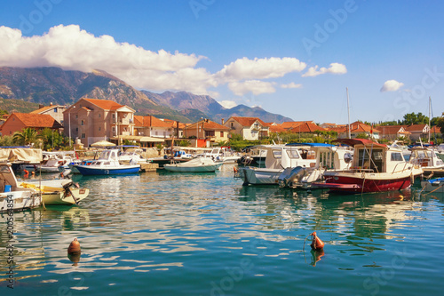 Sunny landscape with fishing boats in harbor. Montenegro, Marina Kalimanj in Tivat city