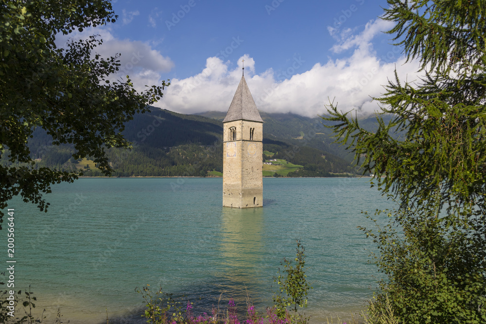 Church Tower in the Resia  Lake, Italy .  Mountains of South Tyrol.