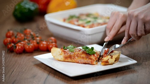 Homemade chicken enchiladas in a white casserole dish. To eat enchiladas with chicken photo