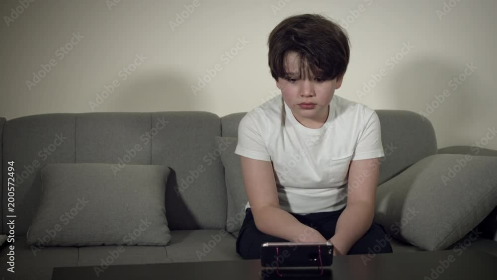 4K Tech-Addicted Child Watching Happy his Smartphone 4K Tech-Addicted Child Watching Happy his Smartphone