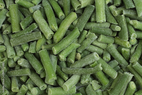 frozen chopped asparagus beans. top view. background green wax beans.