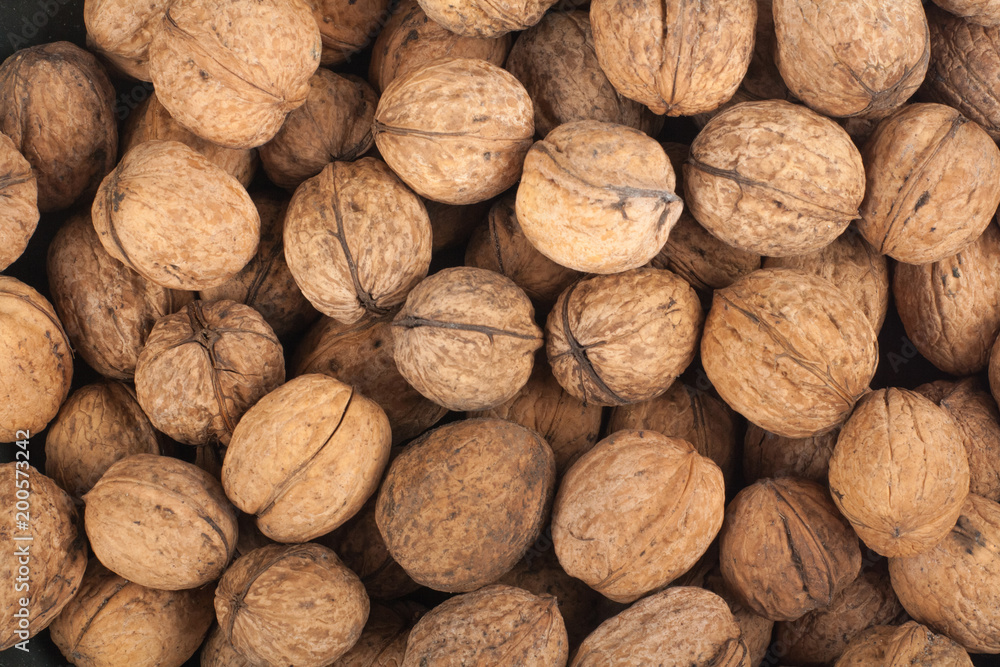 Scattered pile of walnuts, background, fresh, walnuts, market. Top view Scattered pile of walnuts, background, fresh, walnuts, market. Top view