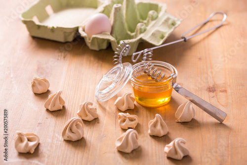 Little honey meringues on a wooden table