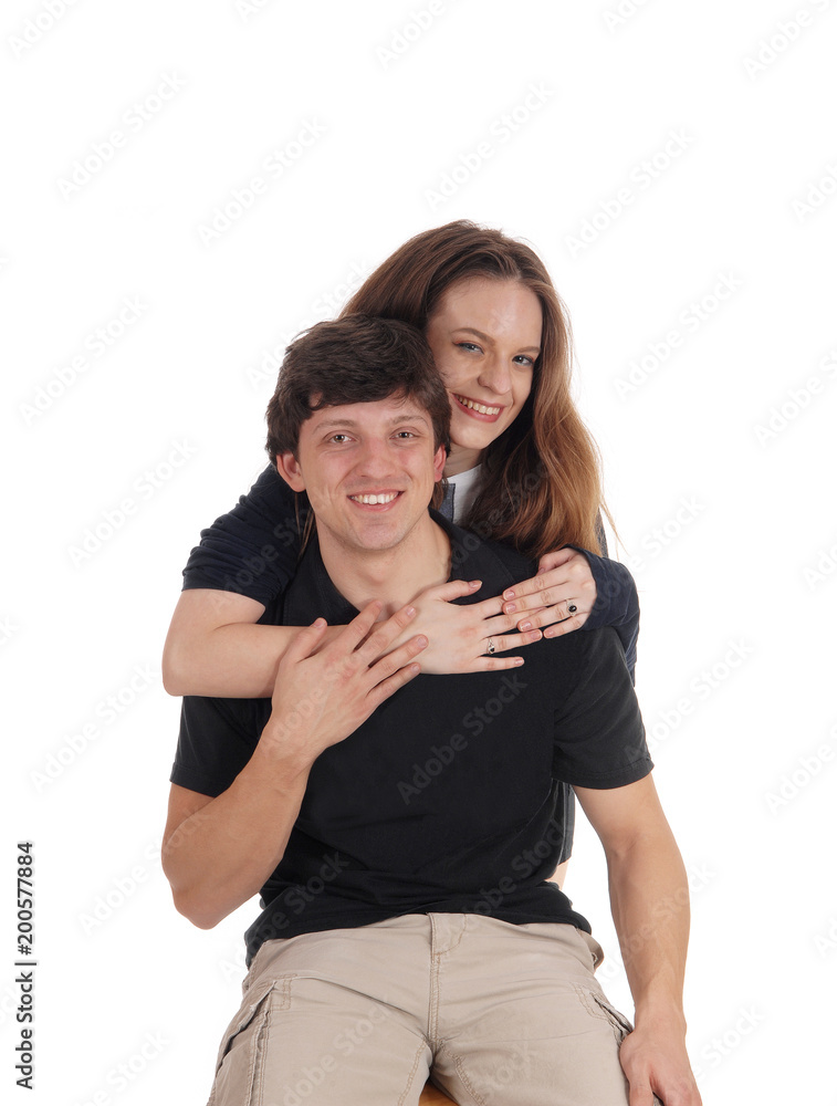 Young couple, she is hugging him from behind Young couple, she is hugging him from behind
