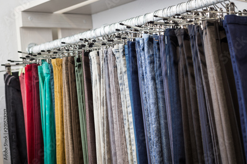 Clothes hang on a shelf in a designer store