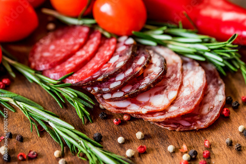 Three sorts of salami with tomatoes and peppercorn