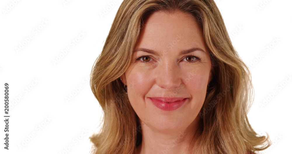 Close up of middle aged Caucasian woman smiling at camera Close up of middle aged Caucasian woman smiling at camera