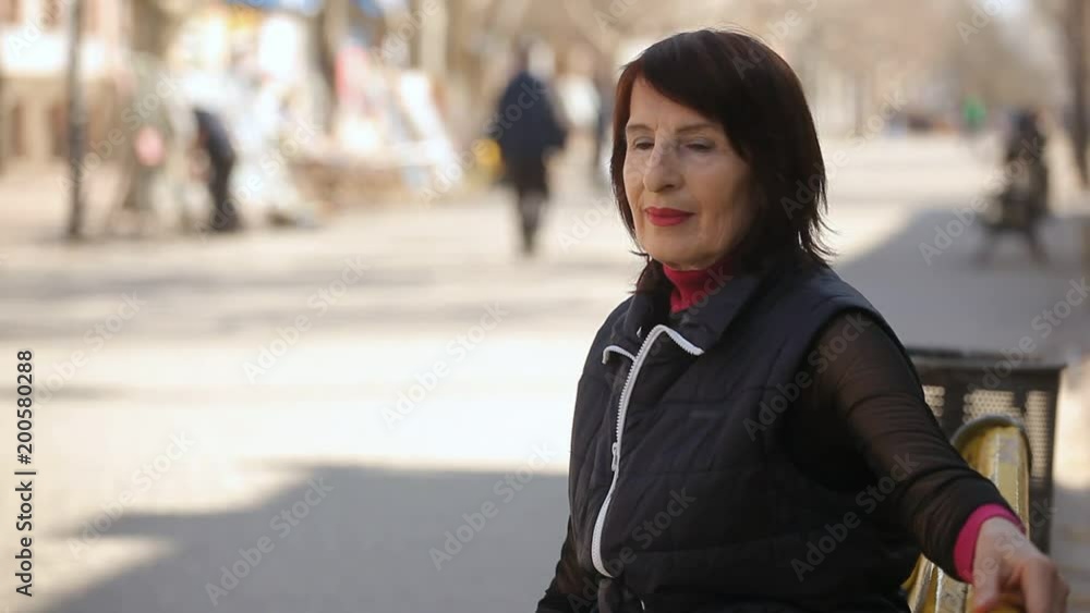 Bokeh profile of a stylish woman with a bob haircut sitting on a bench and remembering her life in the splendid alley on a sunny day in spring Bokeh profile of a stylish woman with a bob haircut sitting on a bench and remembering her life in the splendid alley on a sunny day in spring