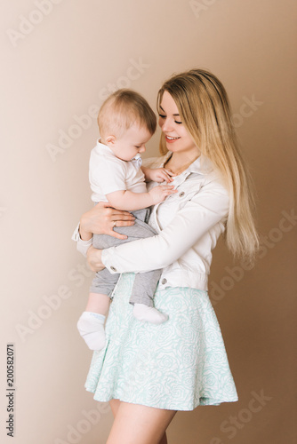Mother playing with baby boy, happy family having fun indoor, cheerful sweet kid portrait, mom and child, healthy toddler, lifting throwing carrying holding up game