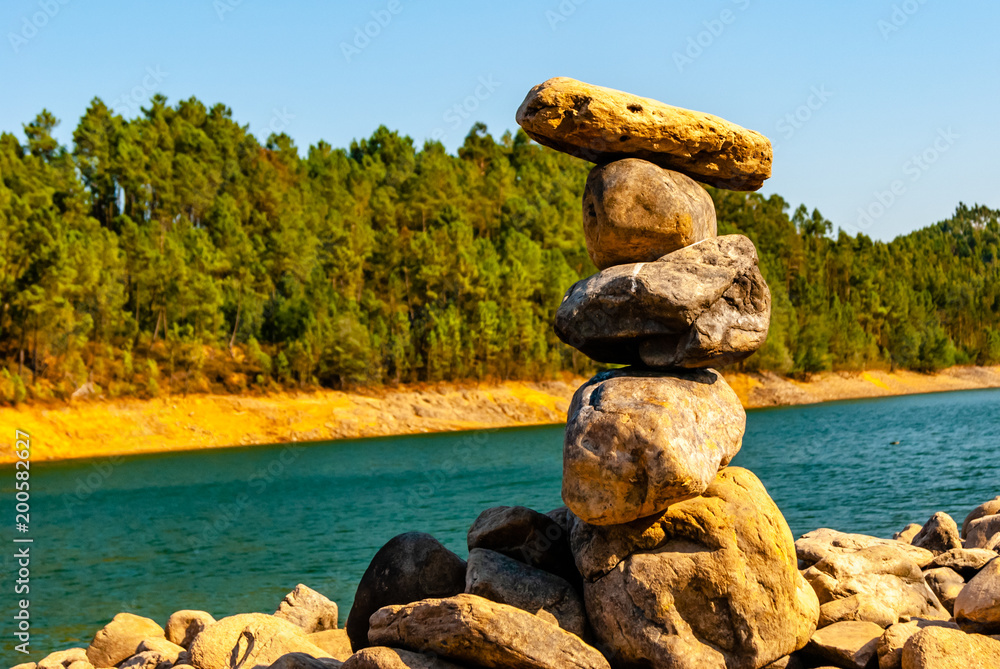 Fototapeta premium Stone pyramid on a floating river.
