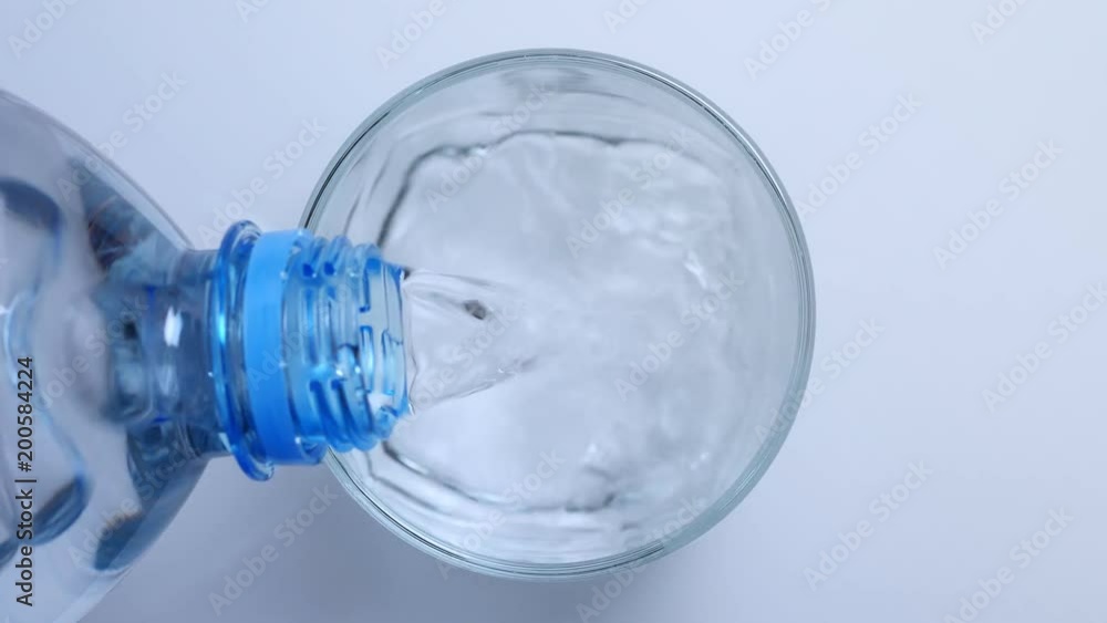 Pouring clean water into the glass. Top view Pouring clean water into the glass. Top view
