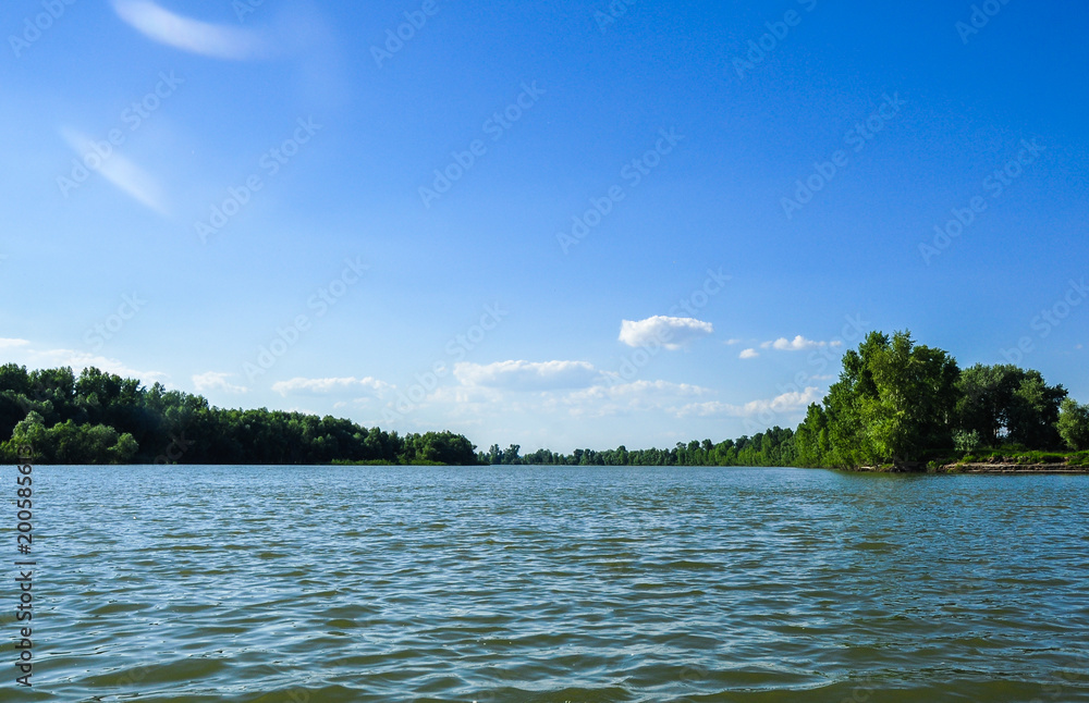 Water surface and wooded beaches of the river Ob. Altai, Russia.