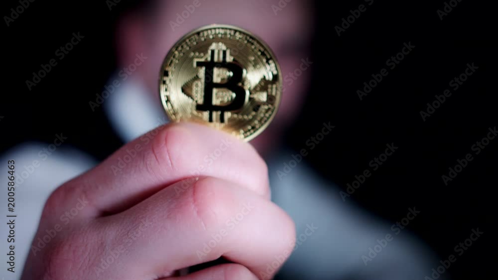 4K Businessman Holding Bitcoin at Camera 4K Businessman Holding Bitcoin at Camera