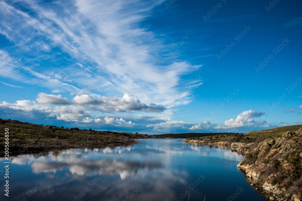 landscape with clouds and reflections in the river