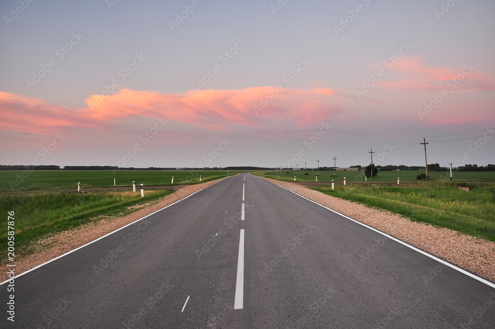 Asphalt road and beautiful cloudy sky at sunset