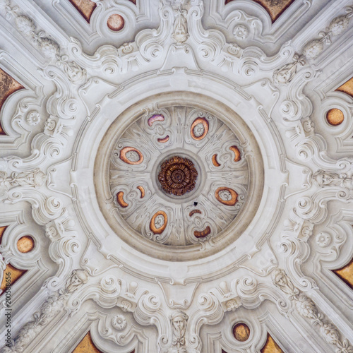 White stucco ceiling sculpted inside a votive chapel.