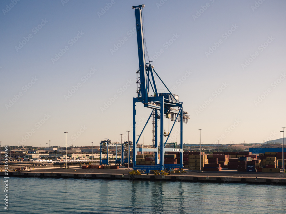 Shipping industrial trade port. Crane bridge and import export container at shipping port harbor.