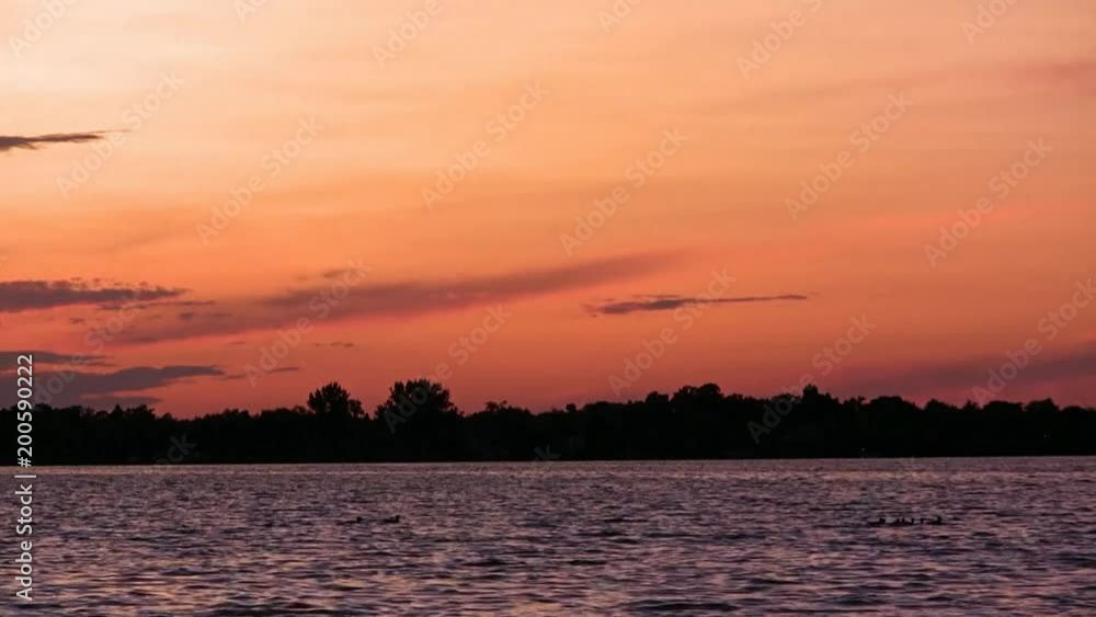 Pontoon and ducks on Lake Irving in Bemidji Minnesota at sunset