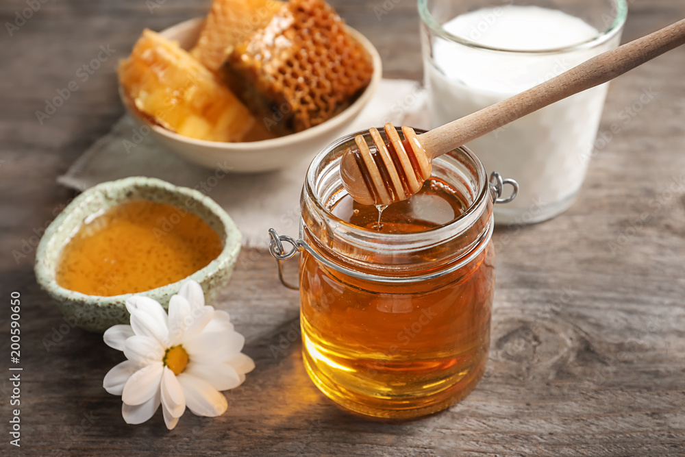 Beautiful composition with milk and honey on wooden background Beautiful composition with milk and honey on wooden background