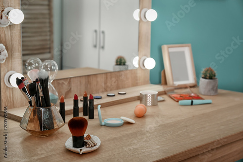 Fototapet Decorative cosmetics and tools on dressing table near mirror in makeup room