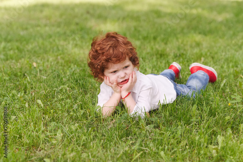 little cute boy lying on grass © Aliaksei Lasevich