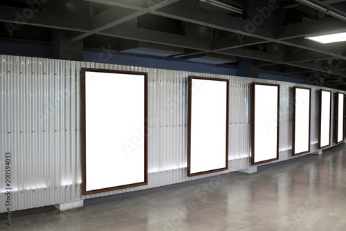 Six movie poster frames along the walkway in modern interior design for movie theater