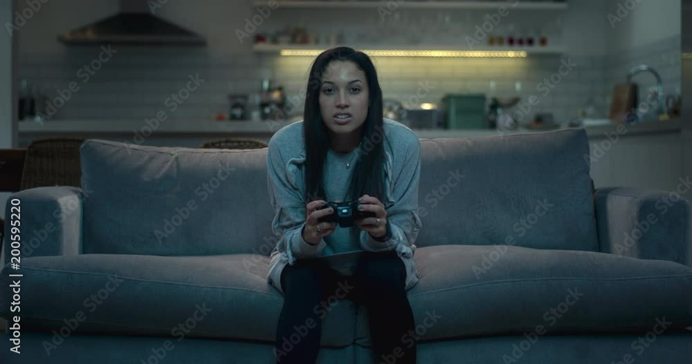 Gamer girl on a sofa at home Gamer girl on a sofa at home