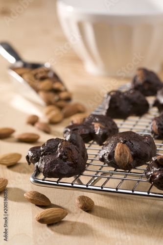 Close-up of dark chocolate almond clusters on cooling rack