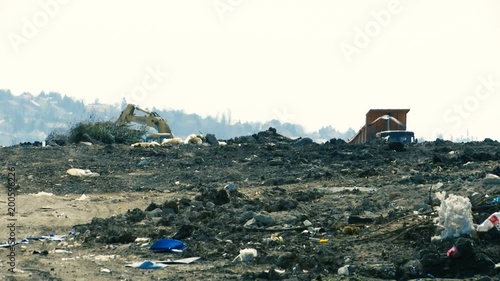 shoot of a dump with machines in the background photo