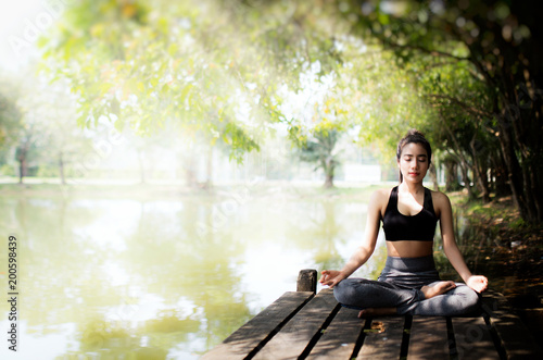 young women meditate while doing yoga in atmosphere peaceful. © ibravery
