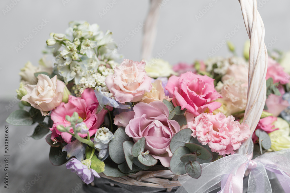 Beautiful flower composition a bouquet in a wicker basket. Floristry concept. Spring colors Beautiful flower composition a bouquet in a wicker basket. Floristry concept. Spring colors