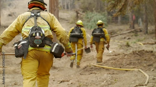 Slow Motion Firefighters Hiking Hose Line During Forest Fire