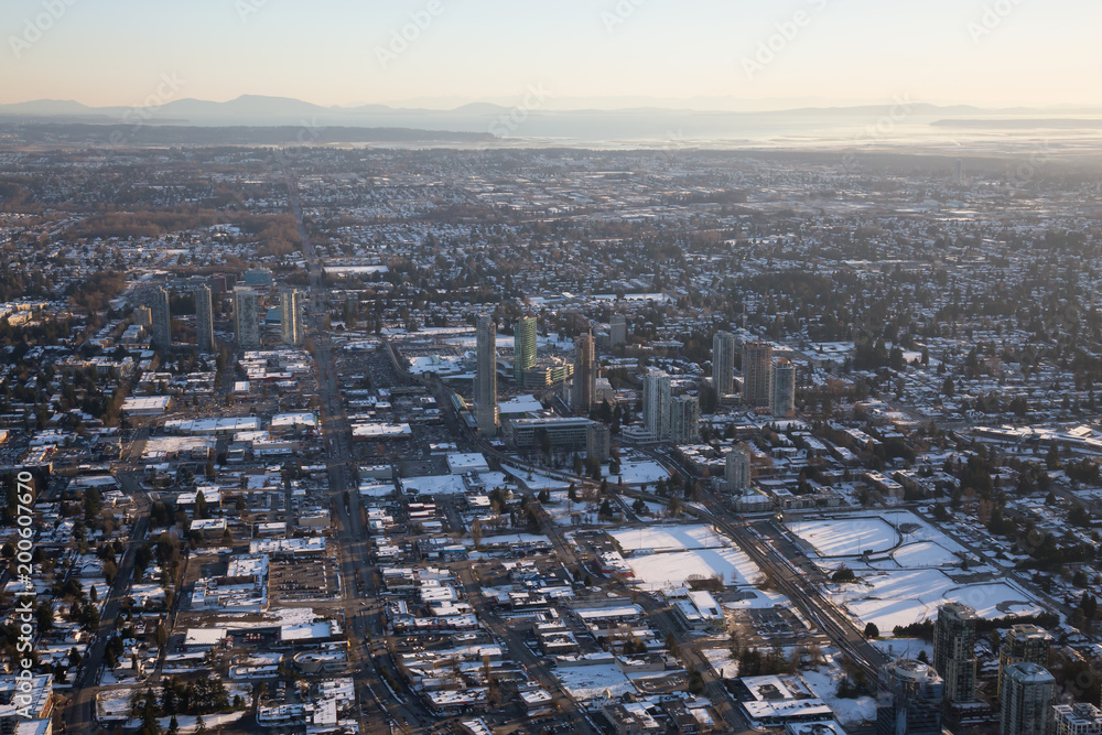 Obraz premium Aerial view of Surrey Central during a vibrant sunset after a snow fall. Taken in Vancouver, British Columbia, Canada.