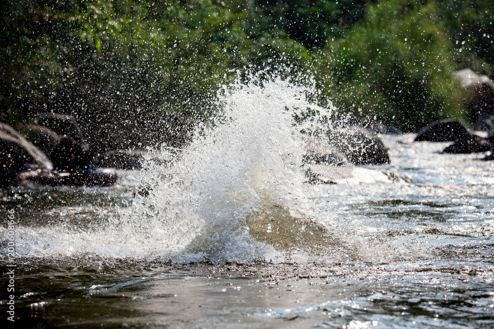 Close-up of water huge splashing in pond from people falling into water, abstract art picture for background Close-up of water huge splashing in pond from people falling into water, abstract art picture for background