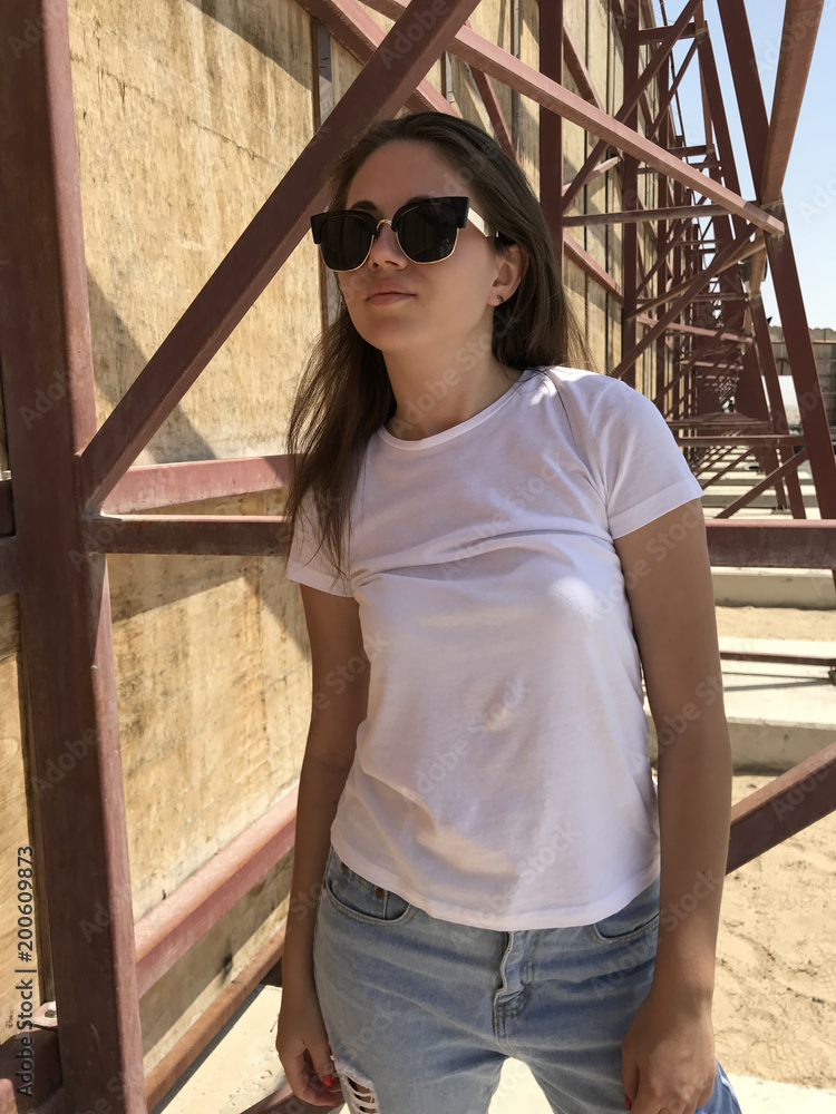 Fototapeta premium Attractive girl in a white t-shirt. Mock-up.