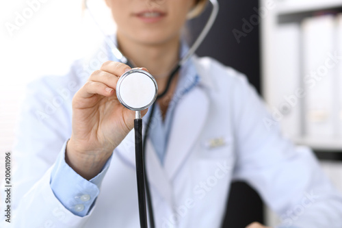 Doctor holds stethoscope head, closeup. Physician ready to examine and help patient. Medical help and insurance in health care, best treatment and medicine concept