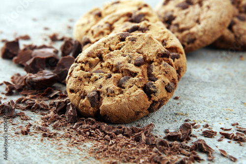 фотография Chocolate cookies on grey table. Chocolate chip cookies shot