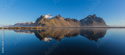panorama perfectly mirrored vestrahorn mountain, blue sky, morning light photo