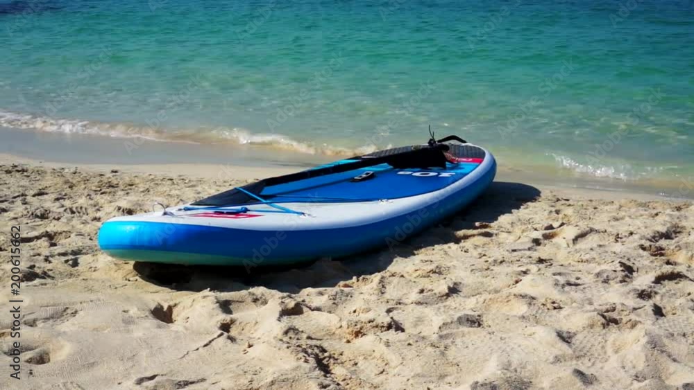 Surfboard on the beach. Sea blue water Surfboard on the beach. Sea blue water