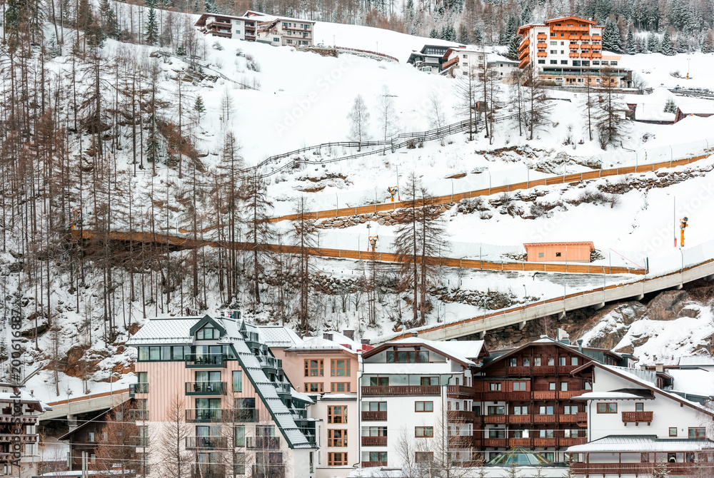 The building of hotels and chalets in the ski Alpine resort. Nature in winter and the mountainside.