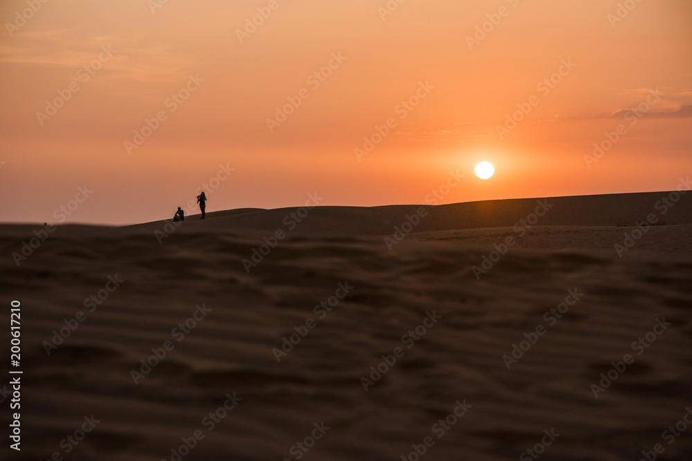 Sun setting below horizon in Mu Ne sand dune in Vietnam