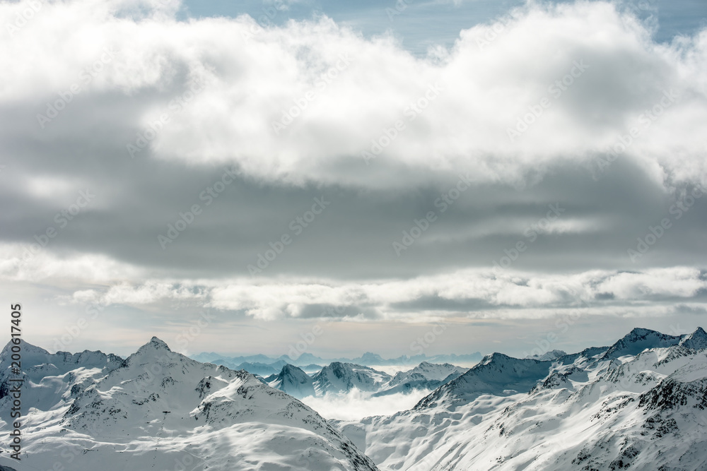 High Alpine landscape. Snow-capped mountain peaks on the horizon