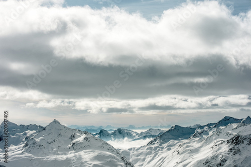 High Alpine landscape. Snow-capped mountain peaks on the horizon