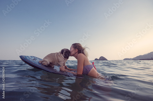 Girl with funny dog in the sea