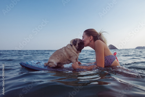 Girl with funny dog in the sea
